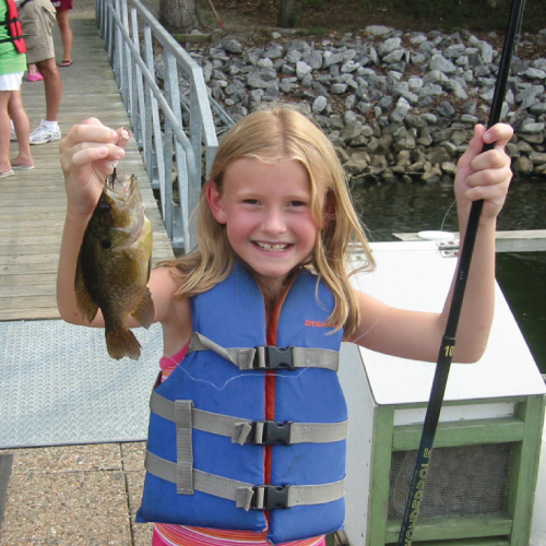 Girl holding up a fish
